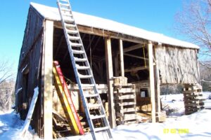 metal ladder on rundown wooden building