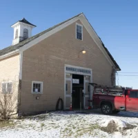 Historic barn restoration project at Lampson Brook Farm in Belchertown, Massachusetts with Colonial Restorations truck outside the building