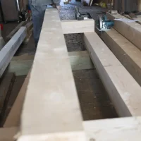 Cutting replacement timber beam for historic barn structural repair in Belchertown Massachusetts