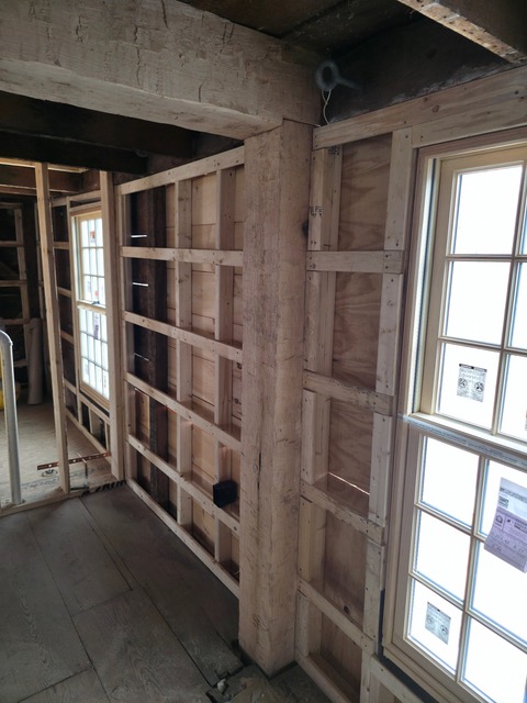 Hand-hewn timber beam and new wall framing in historic Oakham home restoration project