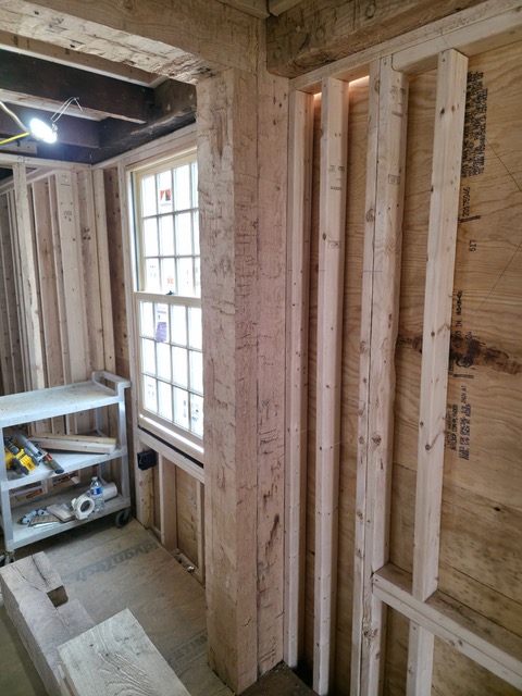 Restored timber framing and window structure in Oakham Massachusetts historic home renovation