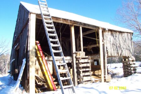 metal ladder on rundown wooden building