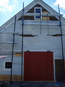 A white building with a red door.