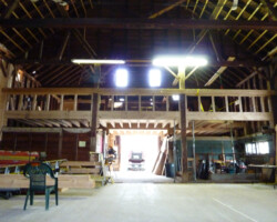 The inside of a barn with wooden beams.