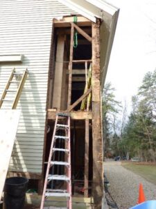 A house is being remodeled with a ladder and a ladder.