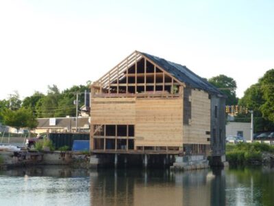 A house that is being built on a body of water.