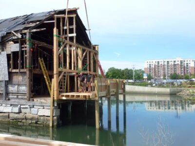 old building in water with exposed wooden beams