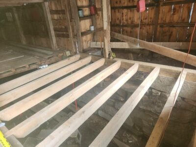 A wooden floor is being built in a barn.
