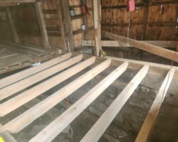 A wooden floor is being built in a barn.