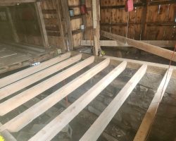 A wooden floor is being built in a barn.